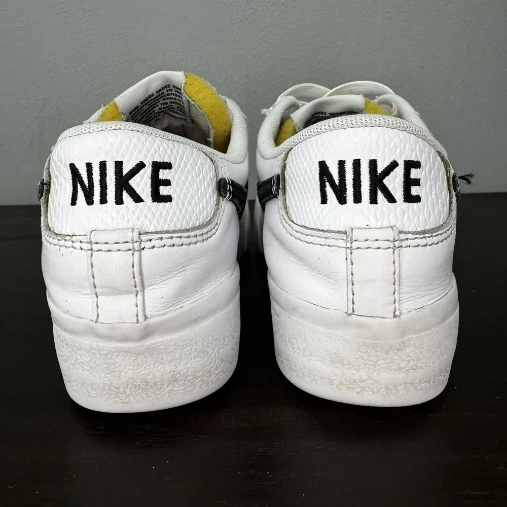 Nike White Leather Low-Top Sneakers with Black Swoosh and Yellow Tongue